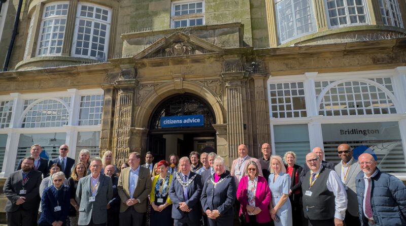 Photograph of staff, volunteers, partners and guests gathered outside the new office of Citizens Advice Hull & East Riding at 6 Manor Street, Bridlington