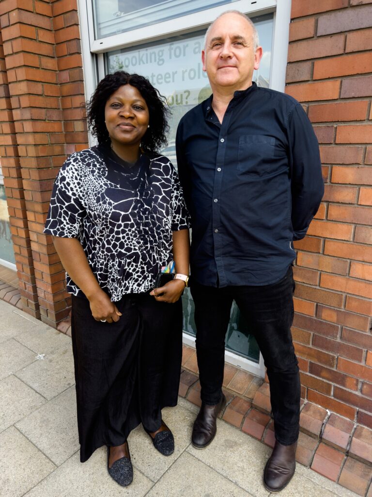 Photograph shows Binta and John standing outside The Wilson Centre in Hull
