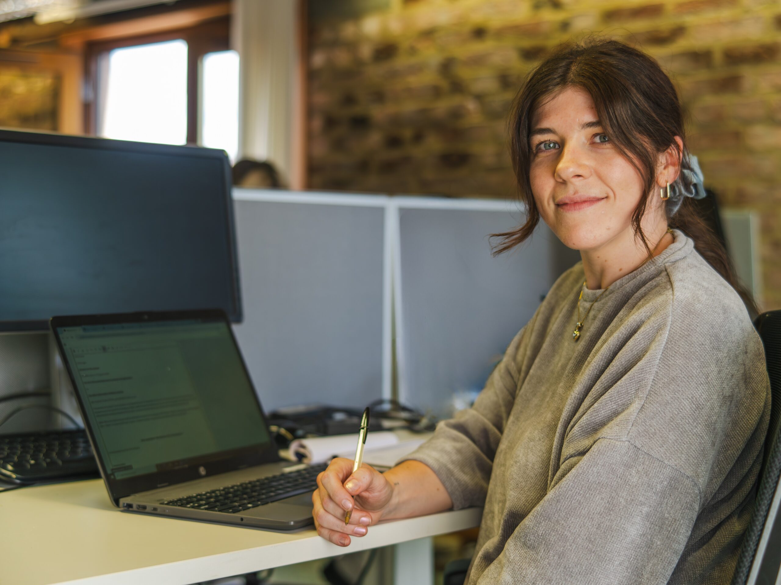 Photograph shows Energy Team adviser Daisy sitting at a desk in the Beverley office of Citizens Advice Hull & East Riding